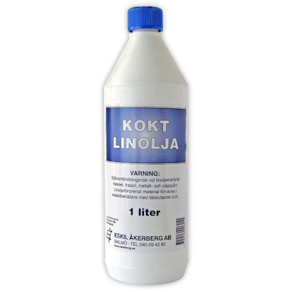 Vit flaska med blå etikett märkt "KOKT LINOLJA" och varningstext om användning. Flaskkapacitet: 1 liter.